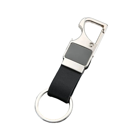Keychain with black strap and silver clip on a dark textured surface